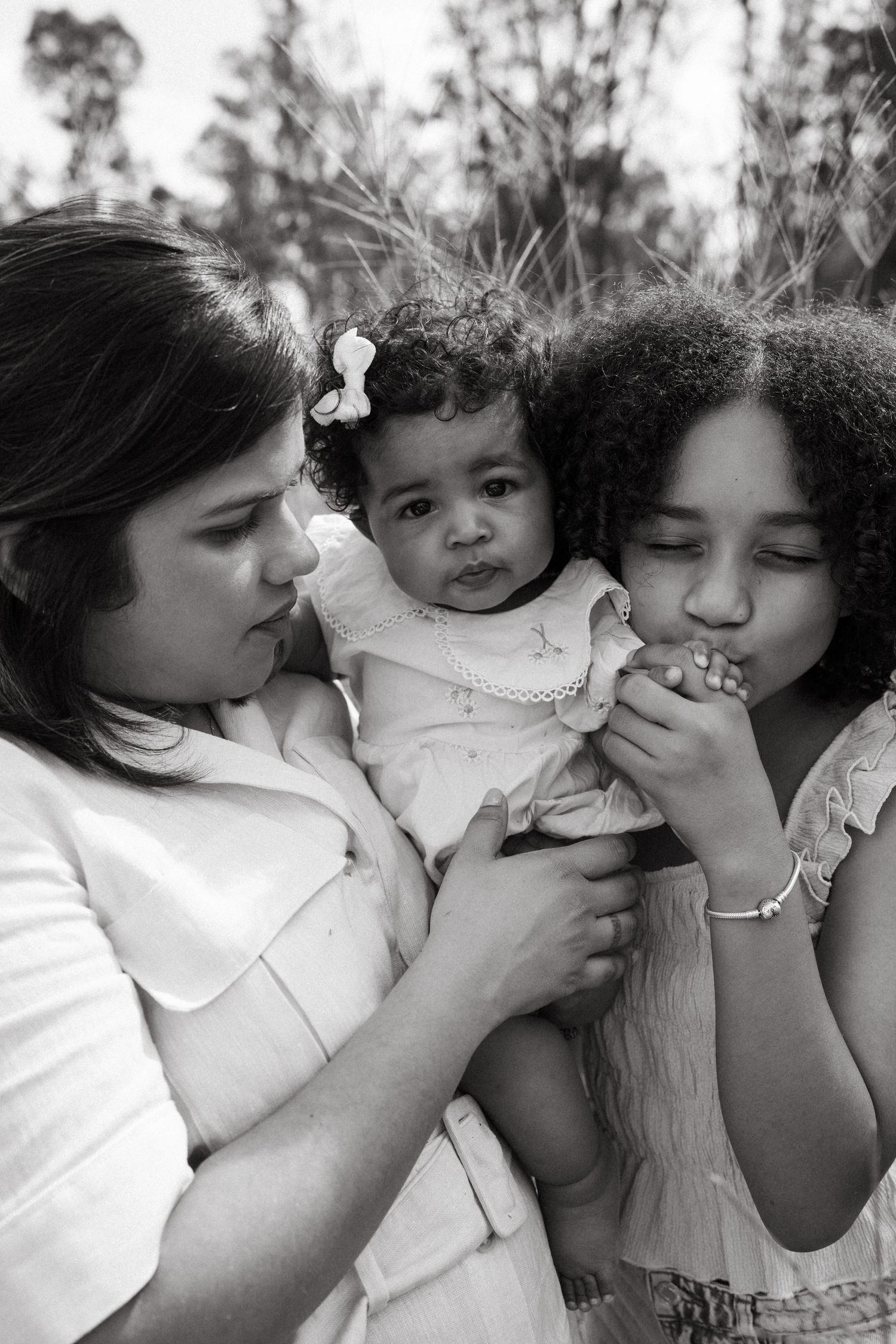 Black and white capture of playful family moments and expressions in nature.