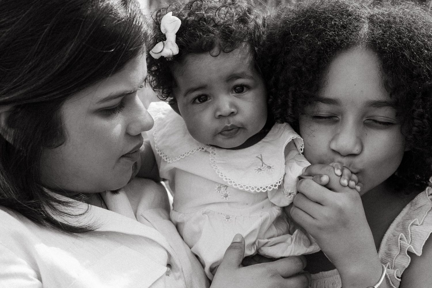 Close-up black and white portrait series showing tender moments and expressions of affection.