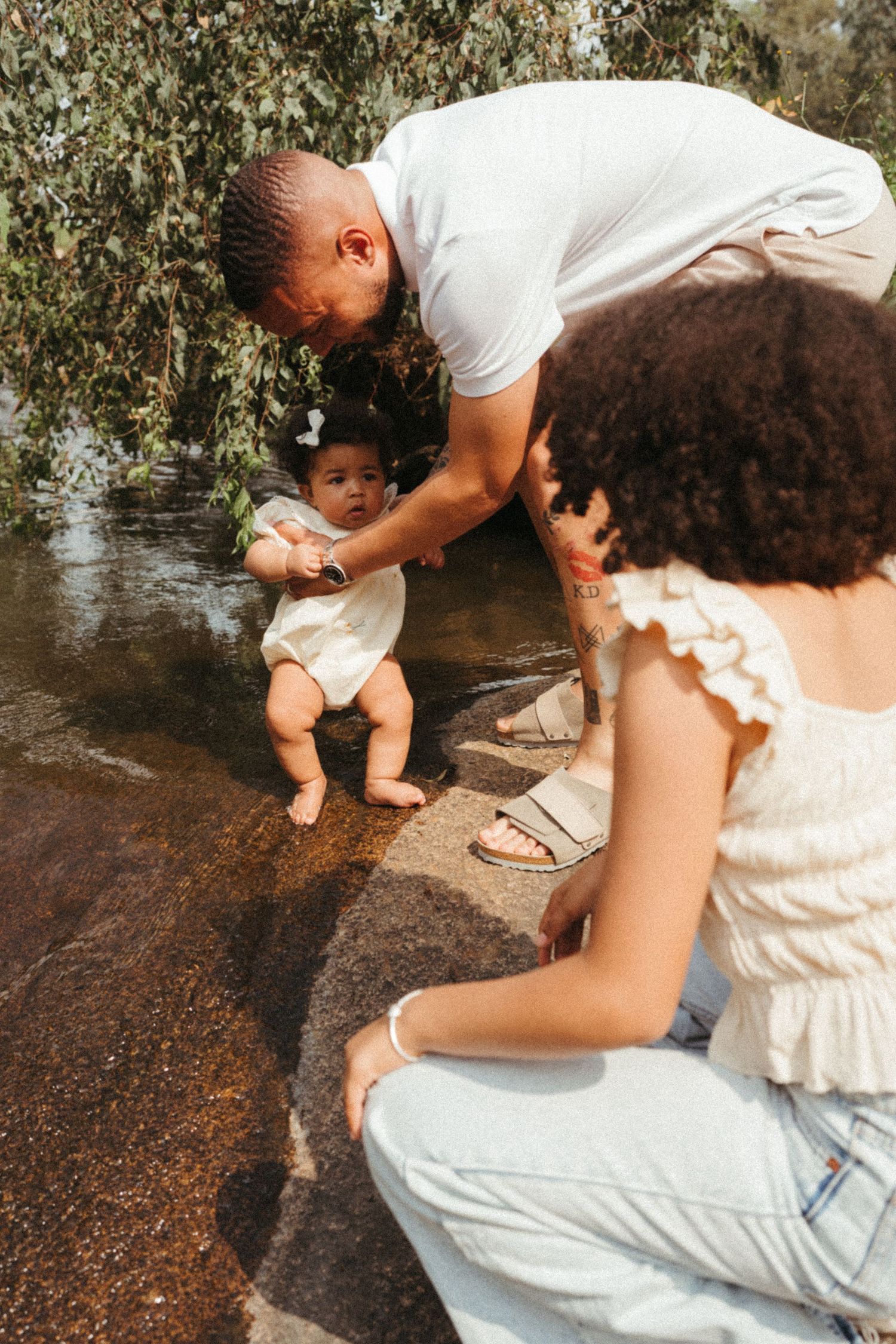 Series of candid moments by the water showing interaction on rocky surface.