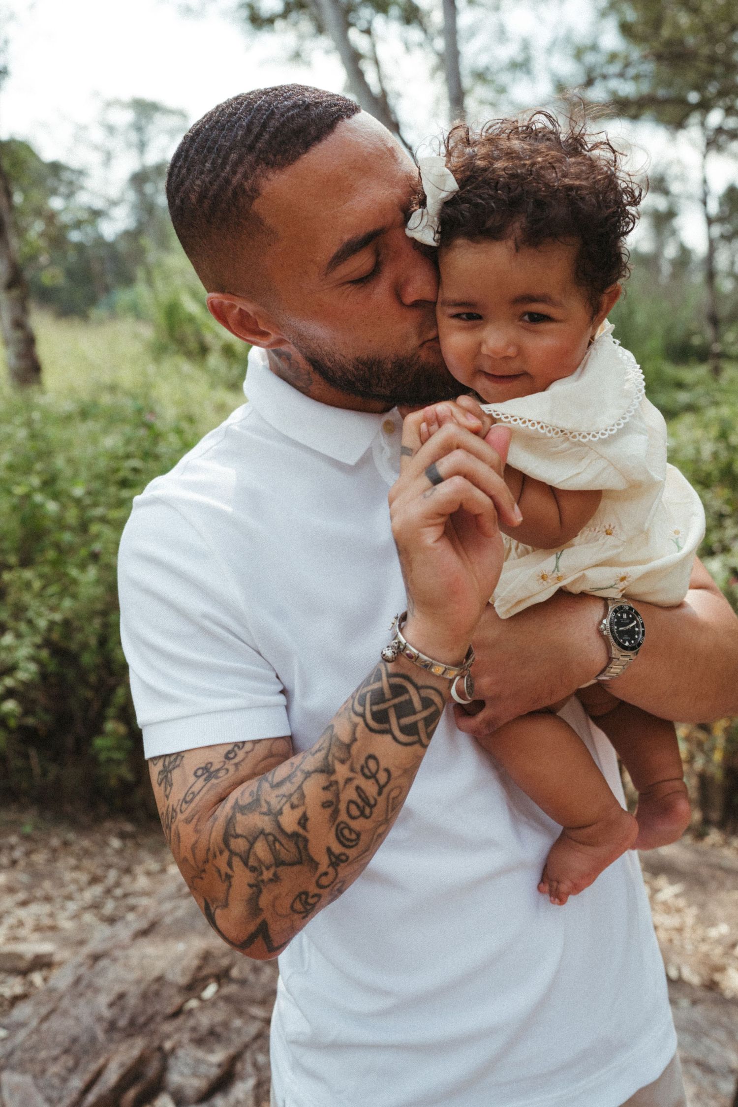 Outdoor photos of parent and child sharing tender moments in white clothing.