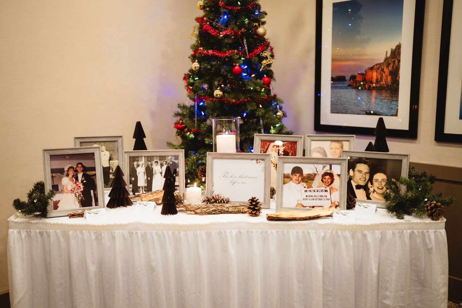 A wedding reception venue decorated with Christmas trees and white tablecloths for a festive holiday celebration.