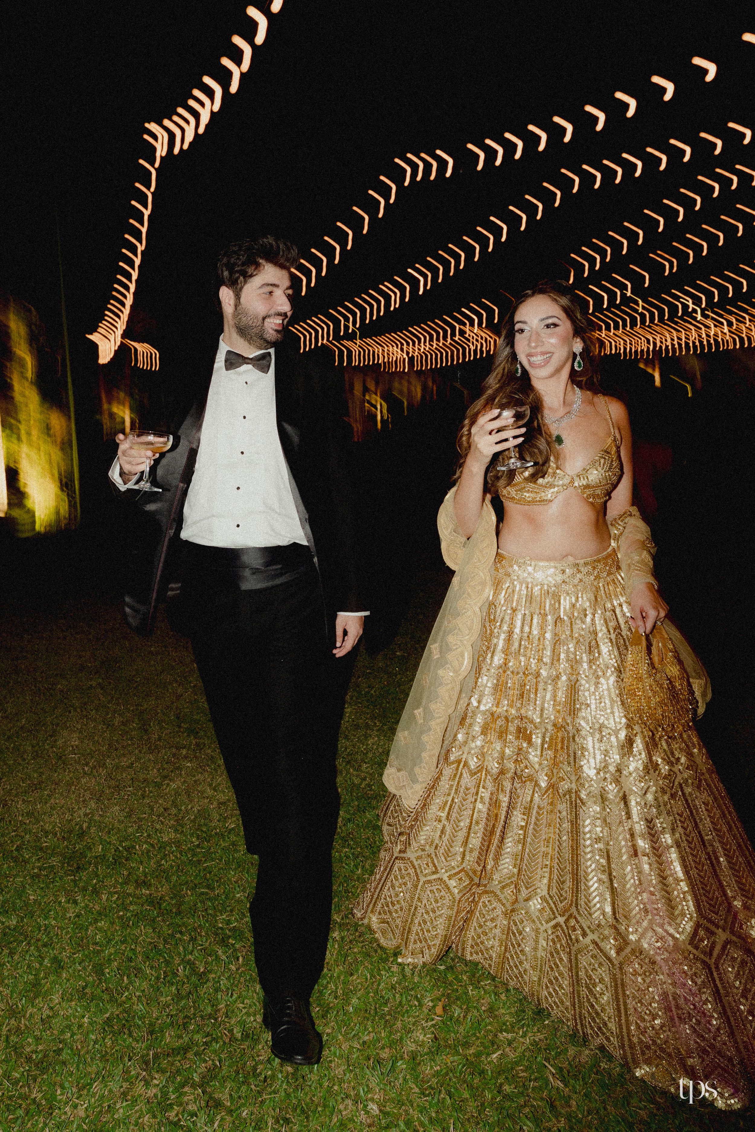 Evening reception couple in formal attire under outdoor string lights, beautifully captured by a professional wedding photographer in Mumbai