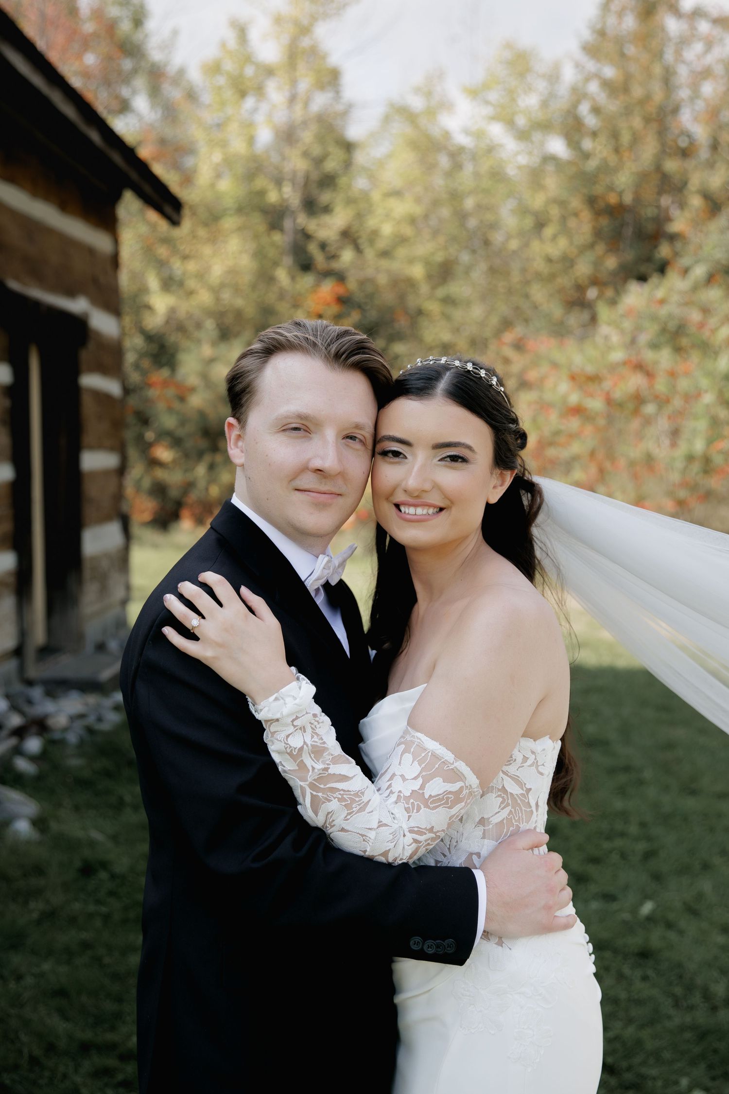 A romantic wedding photoshoot series showing a couple embracing outdoors with autumn trees in the background.