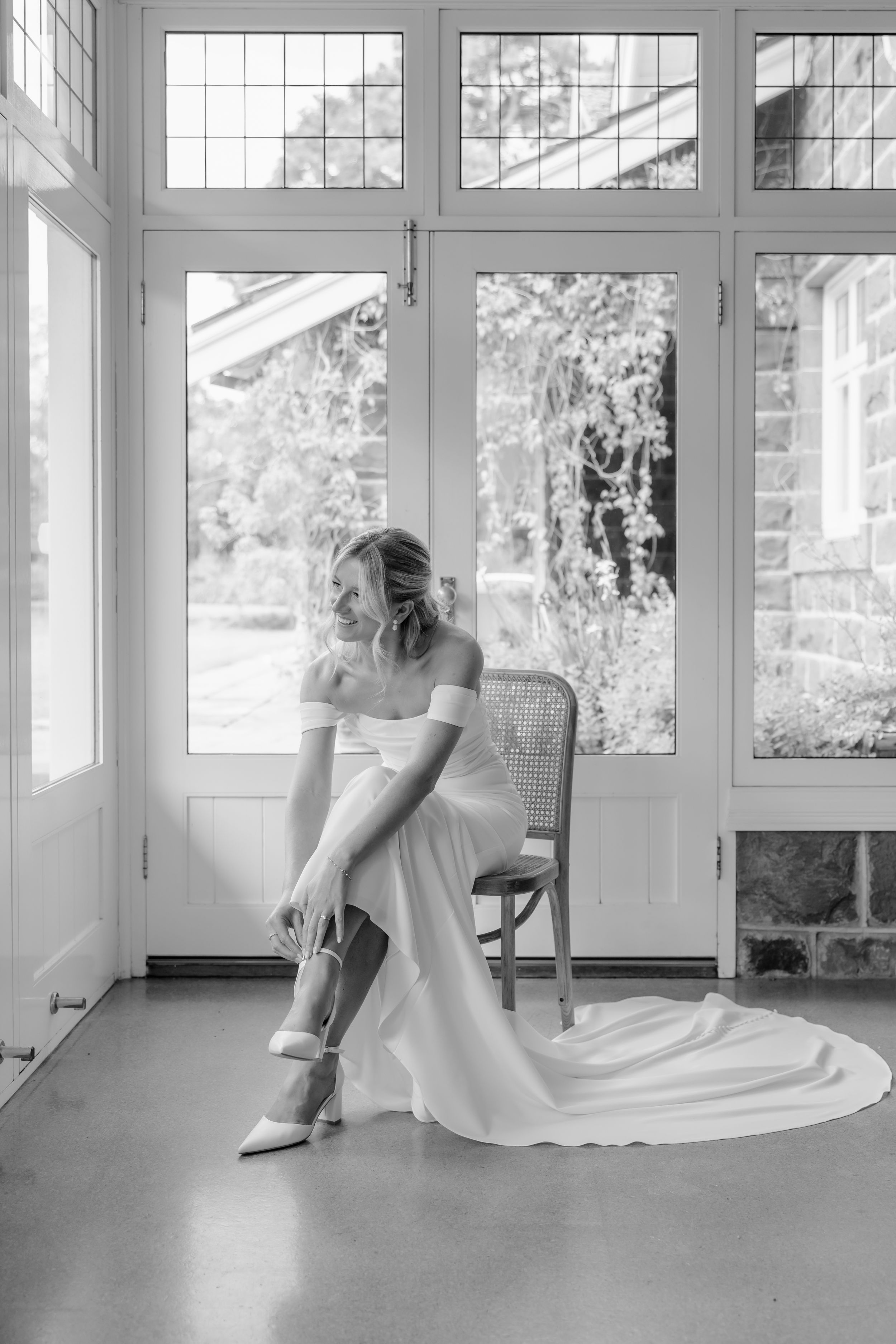 A sunlit bridal portrait series in a bright white room with large windows.