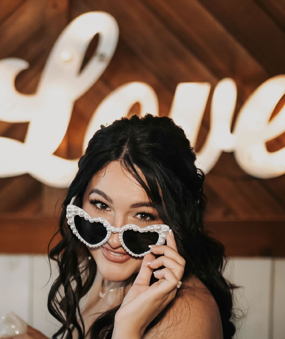 Bride laughing and playing with her fur baby during candid wedding morning moments.