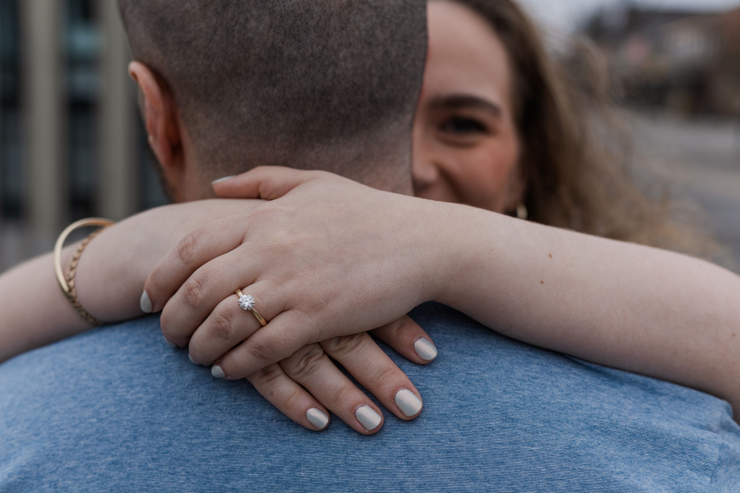 Close-up shots showing hands with wedding rings in various intimate poses against blue denim background.