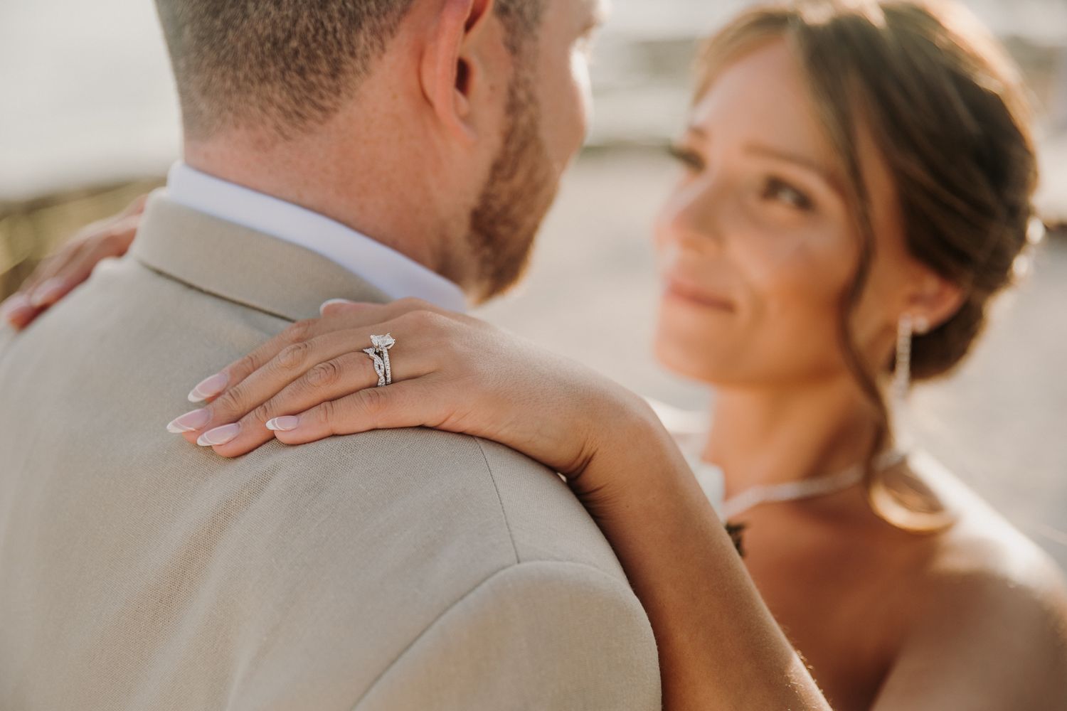 Close up romantic wedding photo showing couple embracing in tender moment during golden hour lighting. El Dorado Royale Wedding Photographer