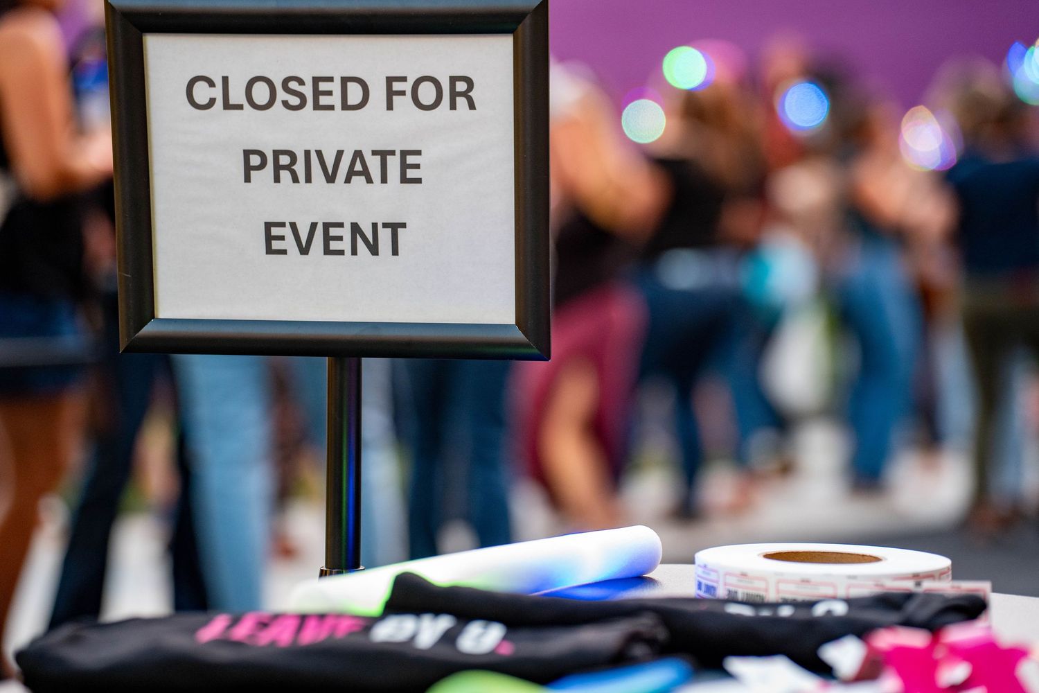 Row of signs indicating a closed private event with blurred background.
