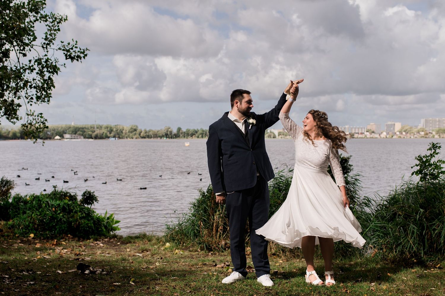 Fotoshoot van bruid en bruidegom lachend, gefotografeerd door christelijke trouwfotograaf uit Huizen