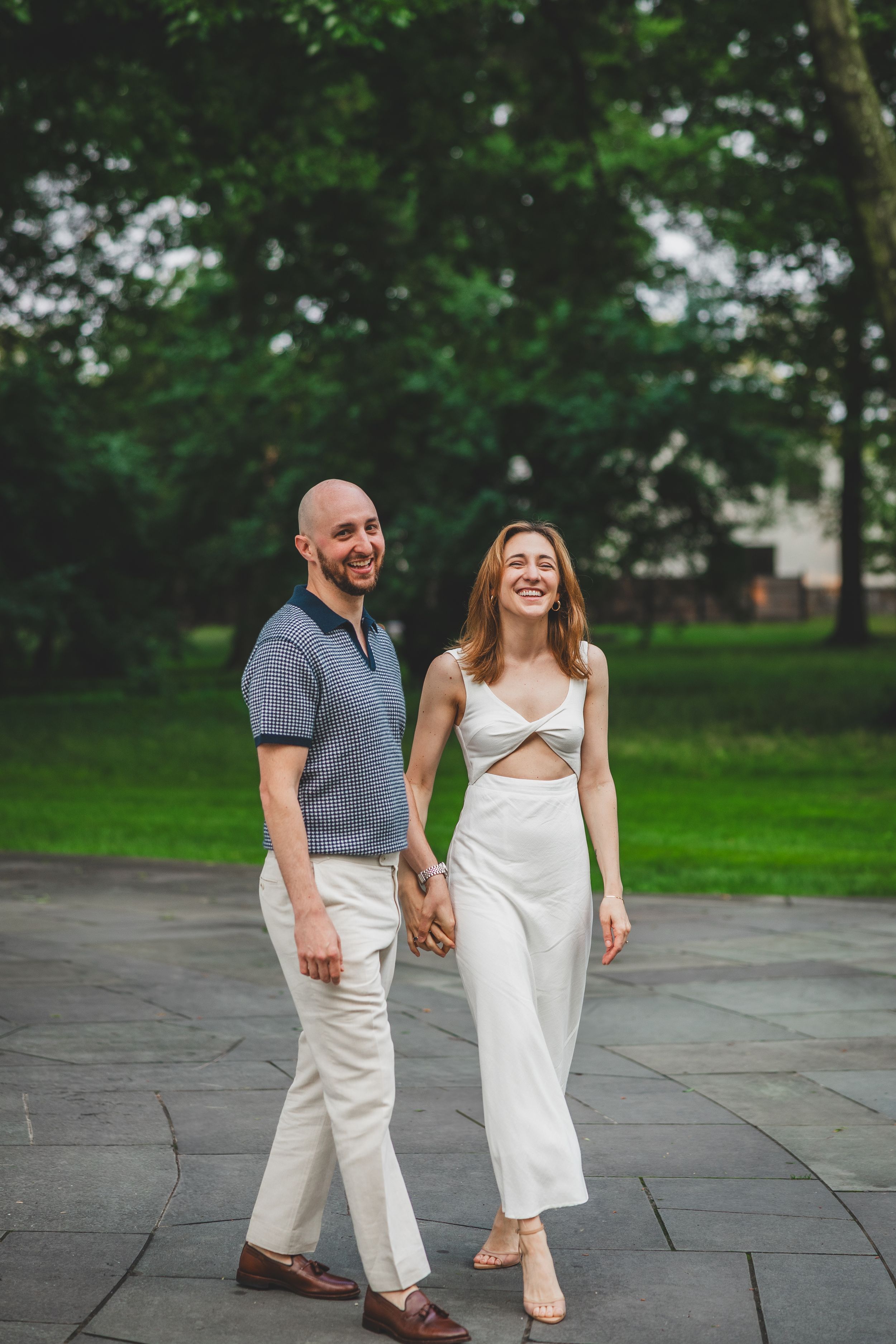 Romantic portrait of a couple holding each other with golden light filtering through the trees