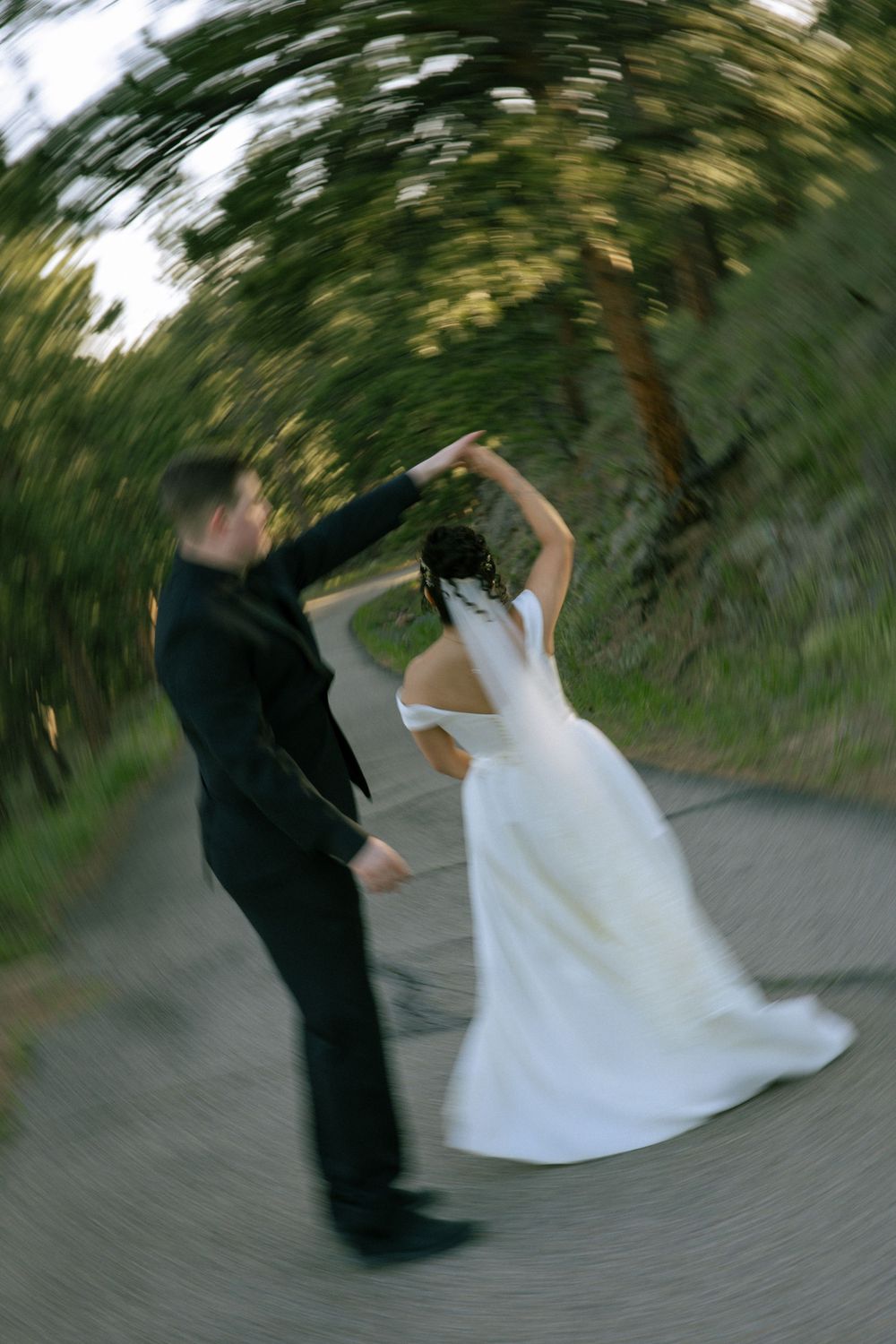 Couple twirling together during outdoor wedding portraits in the Boulder mountains.