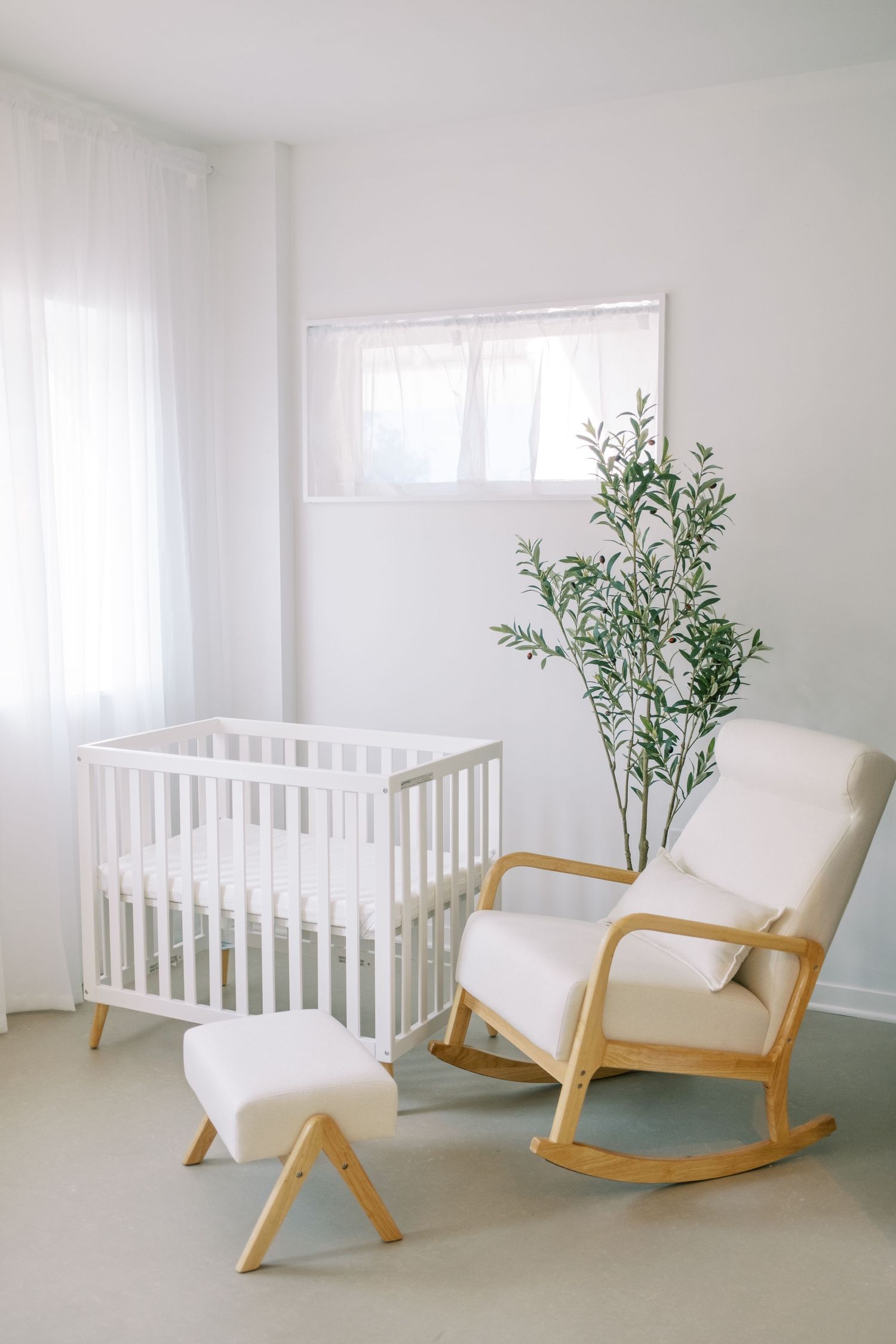Minimalist nursery room with white crib and wooden rocking chair showcased in multiple angles against bright walls.