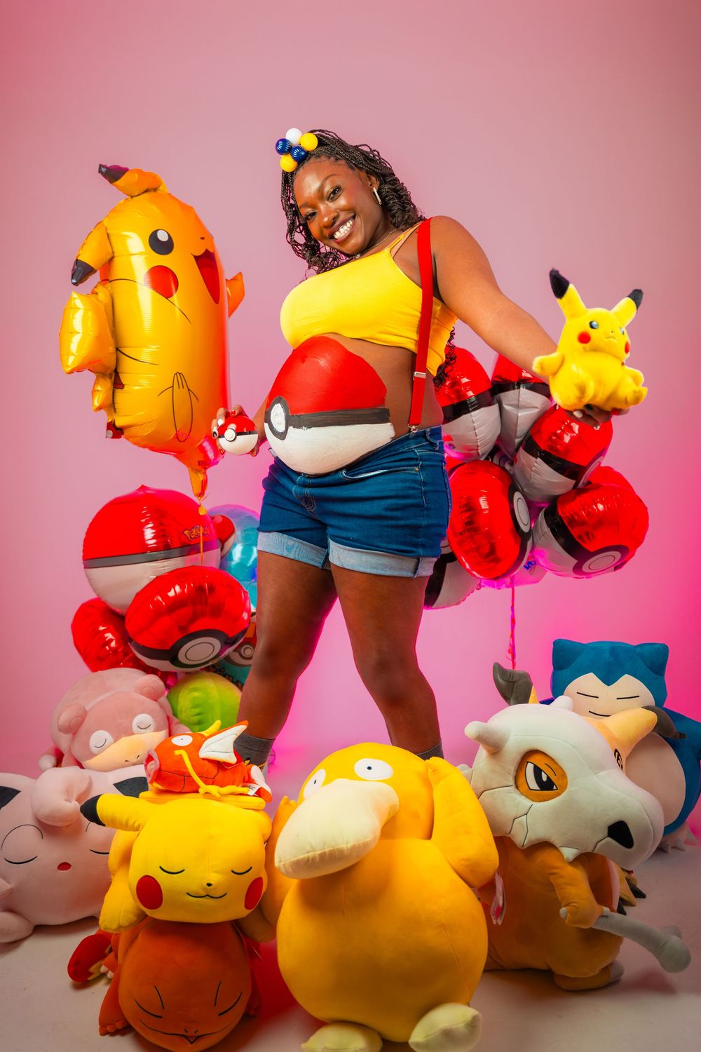 Colorful collection of Pokemon plush toys including Pikachu and other characters arranged against a pink background.