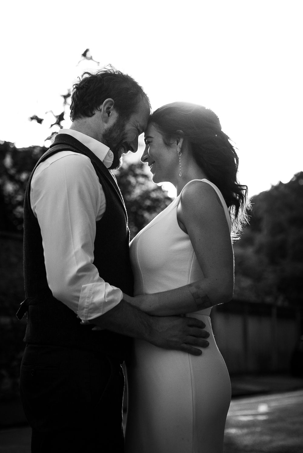 Silhouetted couple embracing in a series of tender moments at sunset.