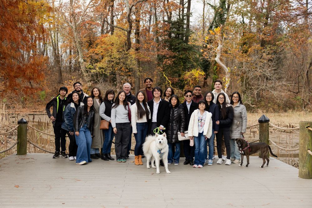 Group photo session in autumn forest with fall foliage and warm colors.