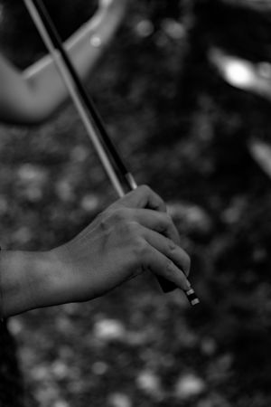 black and white close up photo of hands playing the violin.