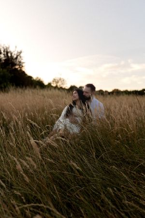 couple in a golden field at sunset.