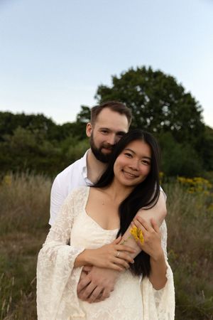 couple in a golden field at sunset.