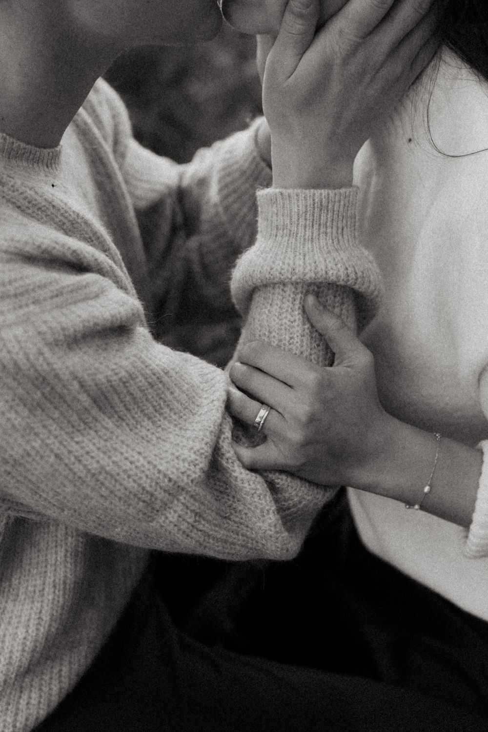 A series of black and white cropped photos showing hands and arms wearing a light-colored knit sweater.