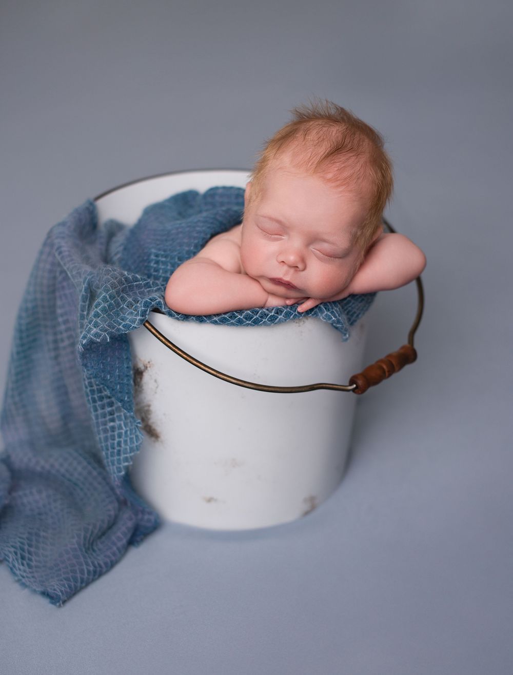 Newborn baby in a bucket