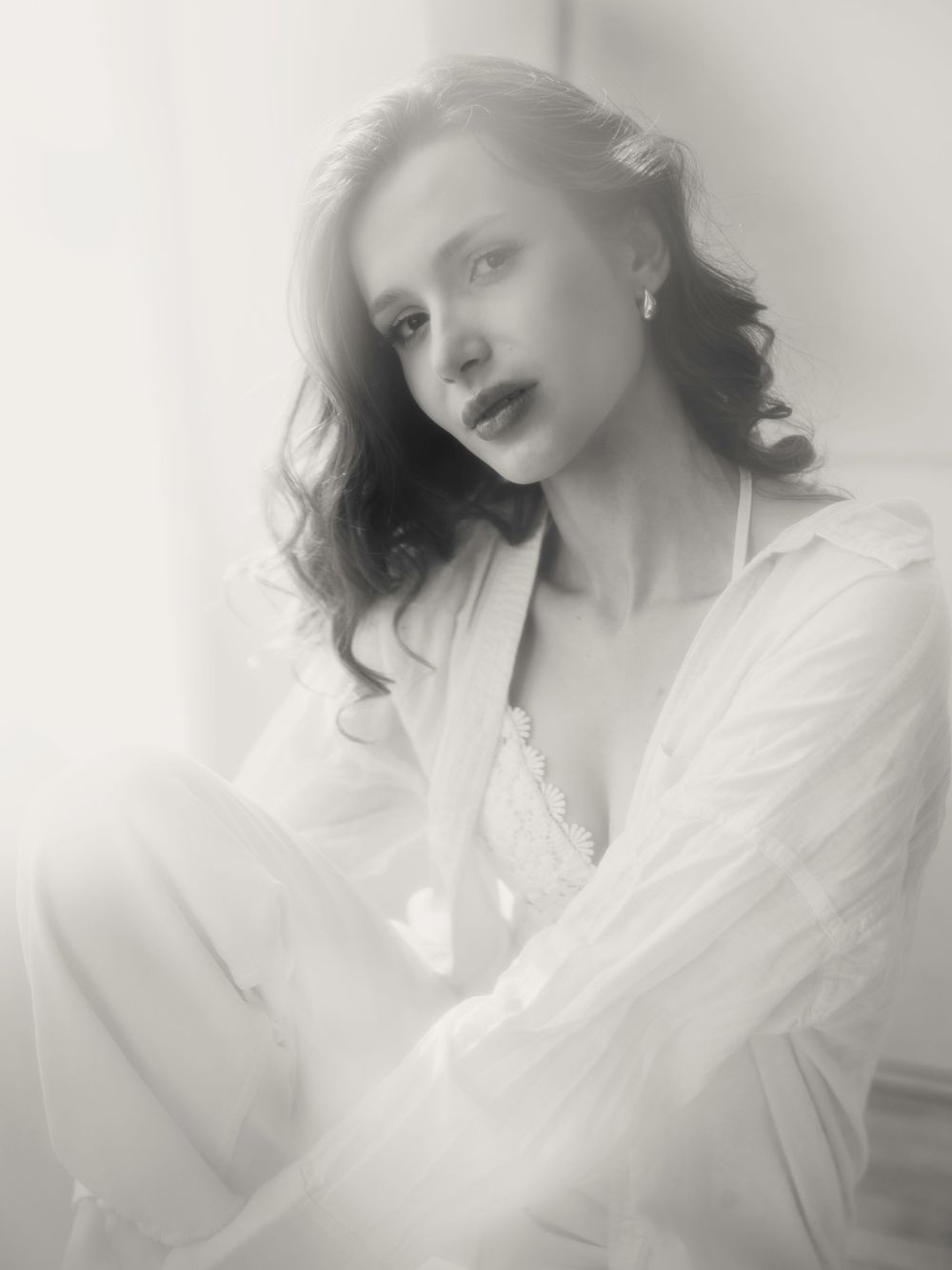 Dreamy black and white portrait photograph showing soft lighting and ethereal mood in classic vintage style.