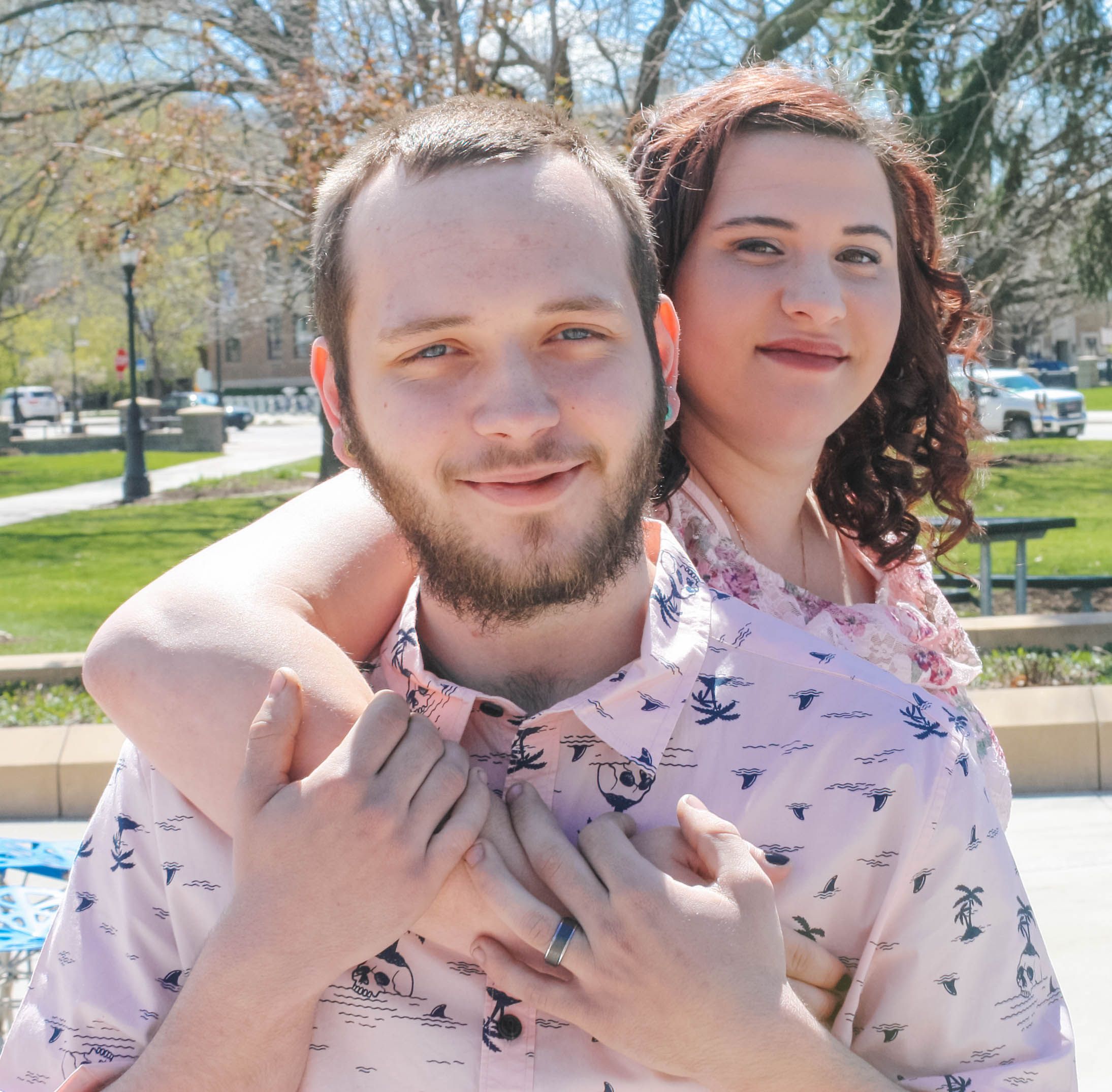 Family members pose together outdoors on sunny spring day.