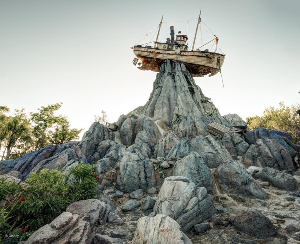 A rusty shipwreck perched atop a rocky mountain formation at Disney's Typhoon Lagoon water park.