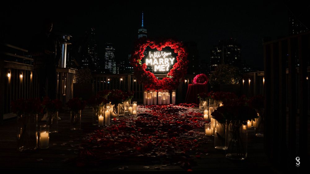 A stunning display of red lanterns illuminates a dark urban street during a nighttime festival celebration.