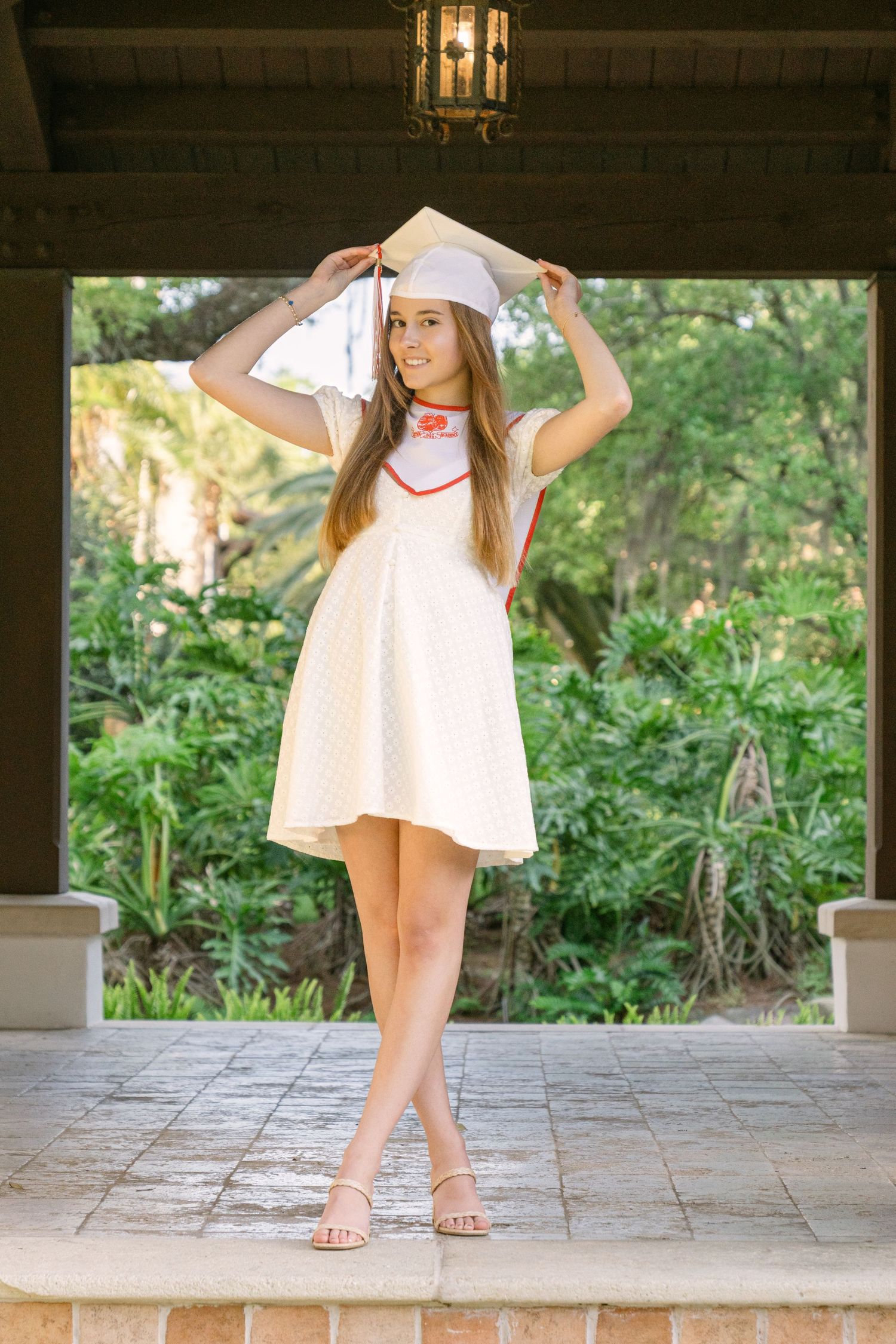 Natural light senior photo of Gabi in a white dress during her luxury senior session on Sea Island