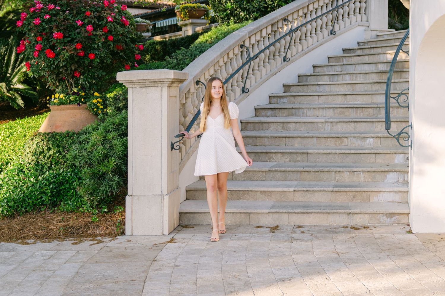 Sea Island senior portrait featuring Gabi walking beneath moss-draped oak trees along the Georgia coast