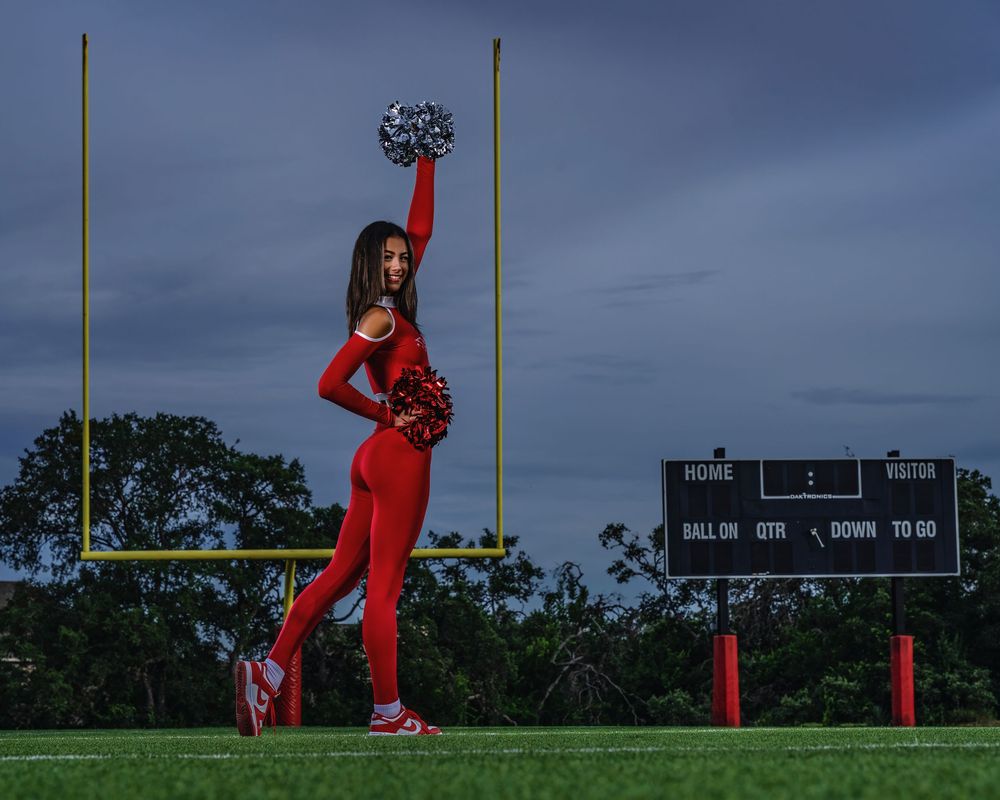 Person in red clothing performs a backflip sequence against a cloudy sky on a grassy field.