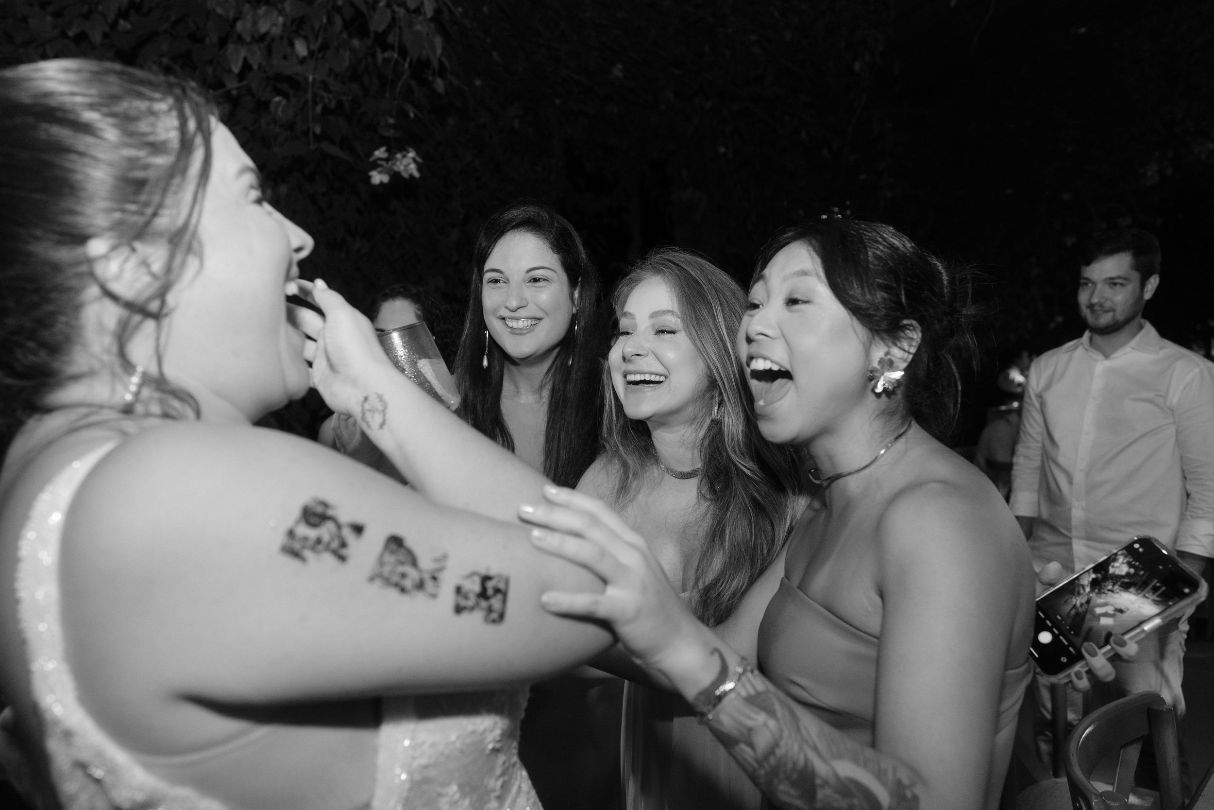 Crowded dance floor with people celebrating and dancing at a festive party.