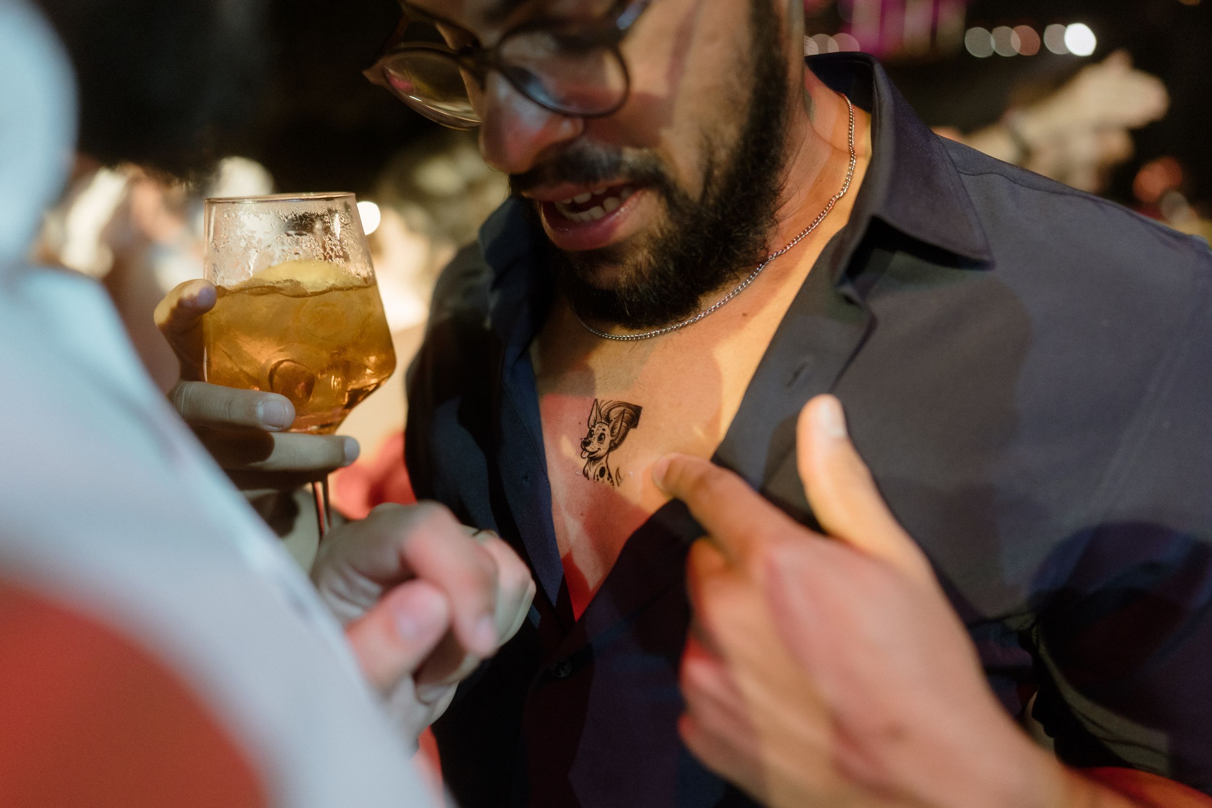 Close-up shots of beverages being enjoyed at a social gathering.