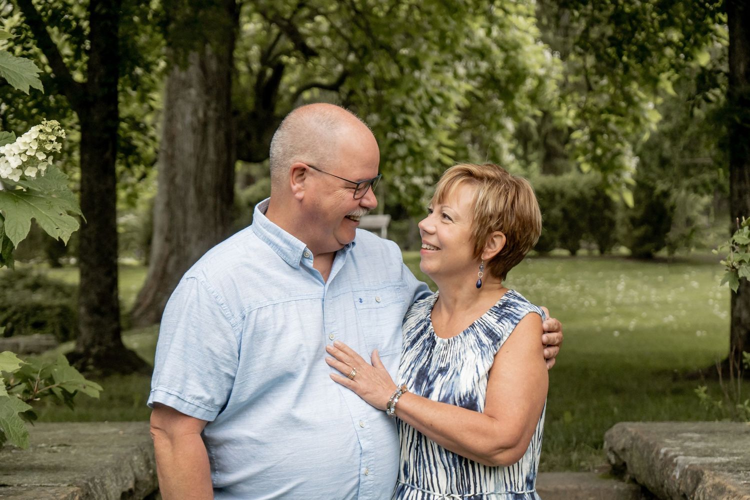 Happy mature couple sharing a loving glance in a lush green park.