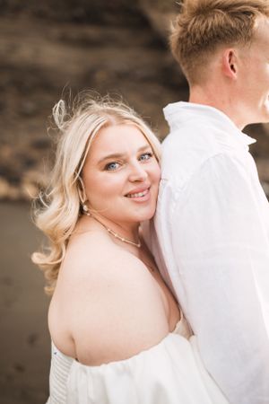 Romantic portrait session against a textured stone backdrop.