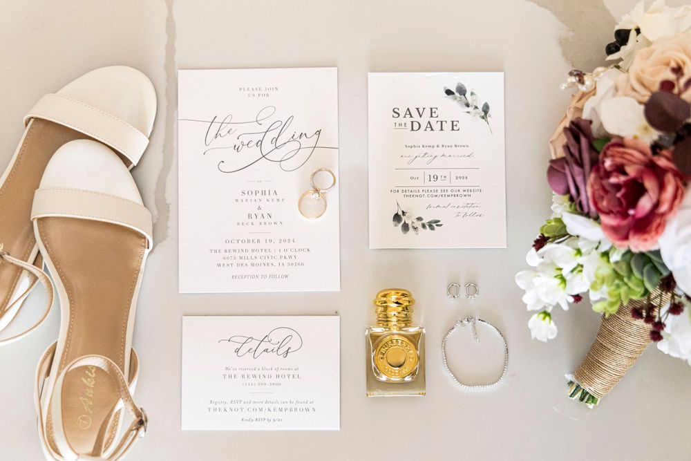 wedding detail photograph of shoes, invitations, save the dates, rsvp, perfume, jewelry and bouquet in Des Moines, Iowa