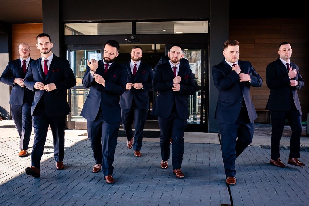 Creative shot of groomsmen's legs and dress shoes walking in synchronization.