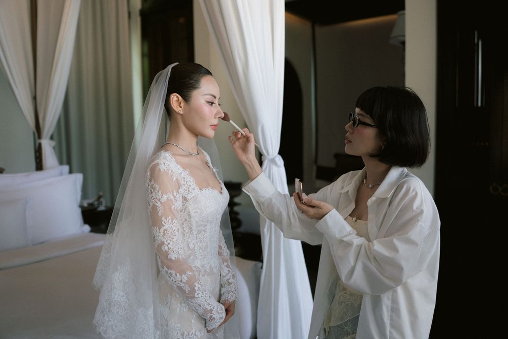 A getting ready sequence showing the final touches of wedding preparation with attendants helping with the dress.