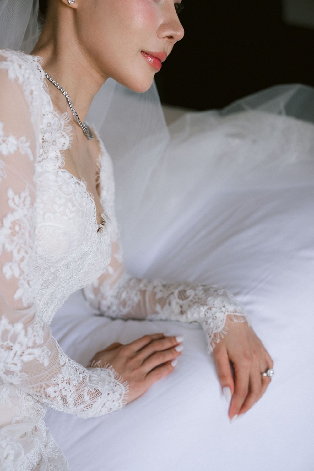 Close-up detail shots of an elegant lace wedding dress with delicate embroidery and sheer fabric.