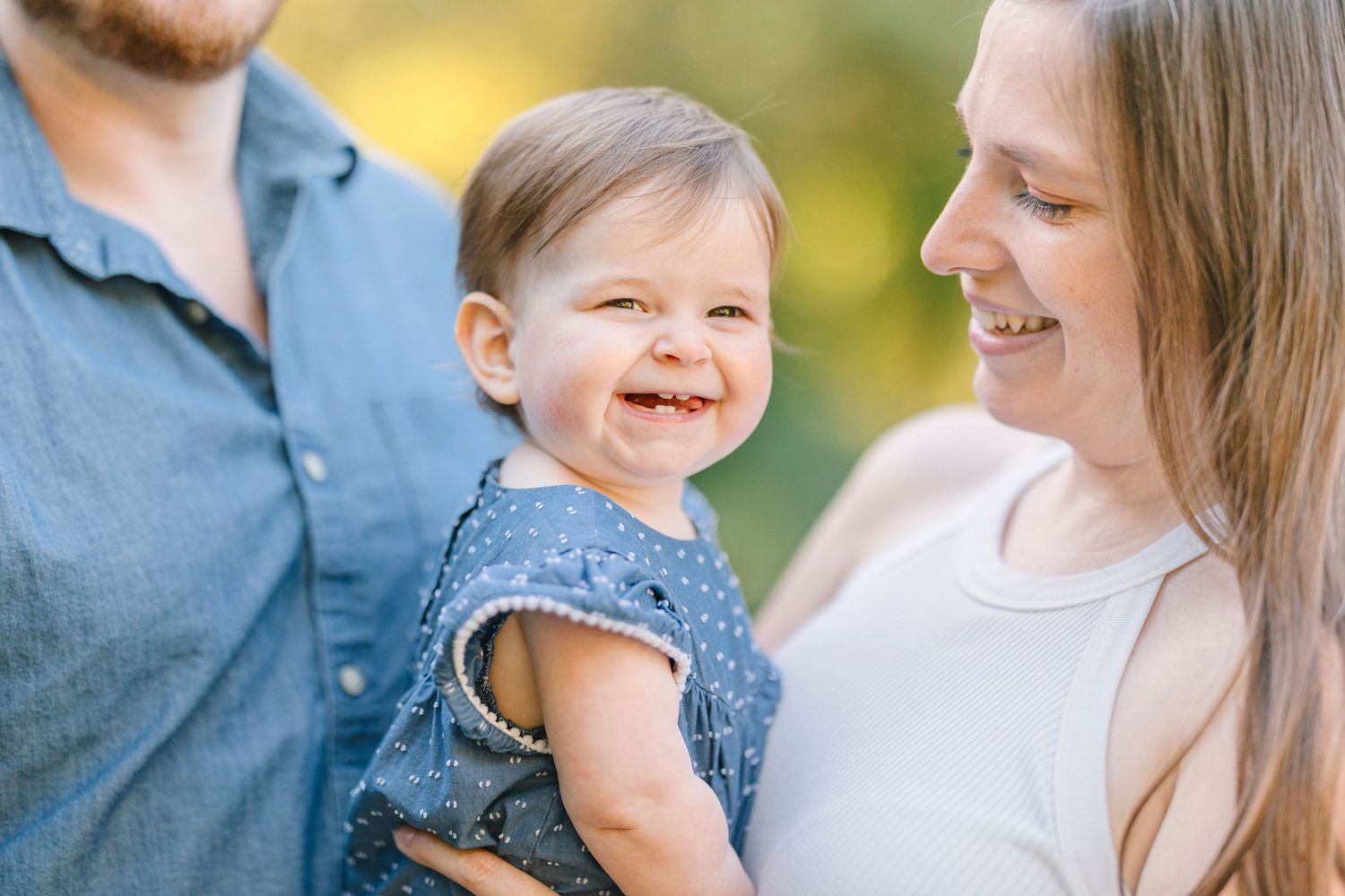 Candid outdoor family photo session showing joyful expressions and natural interactions.