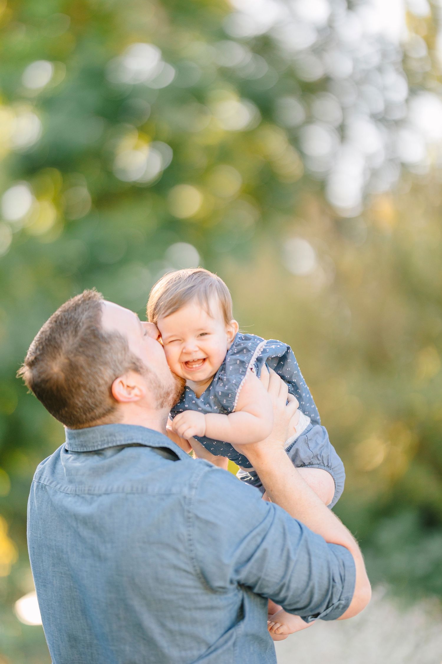 Sweet candid moments between family members during an outdoor photo session.