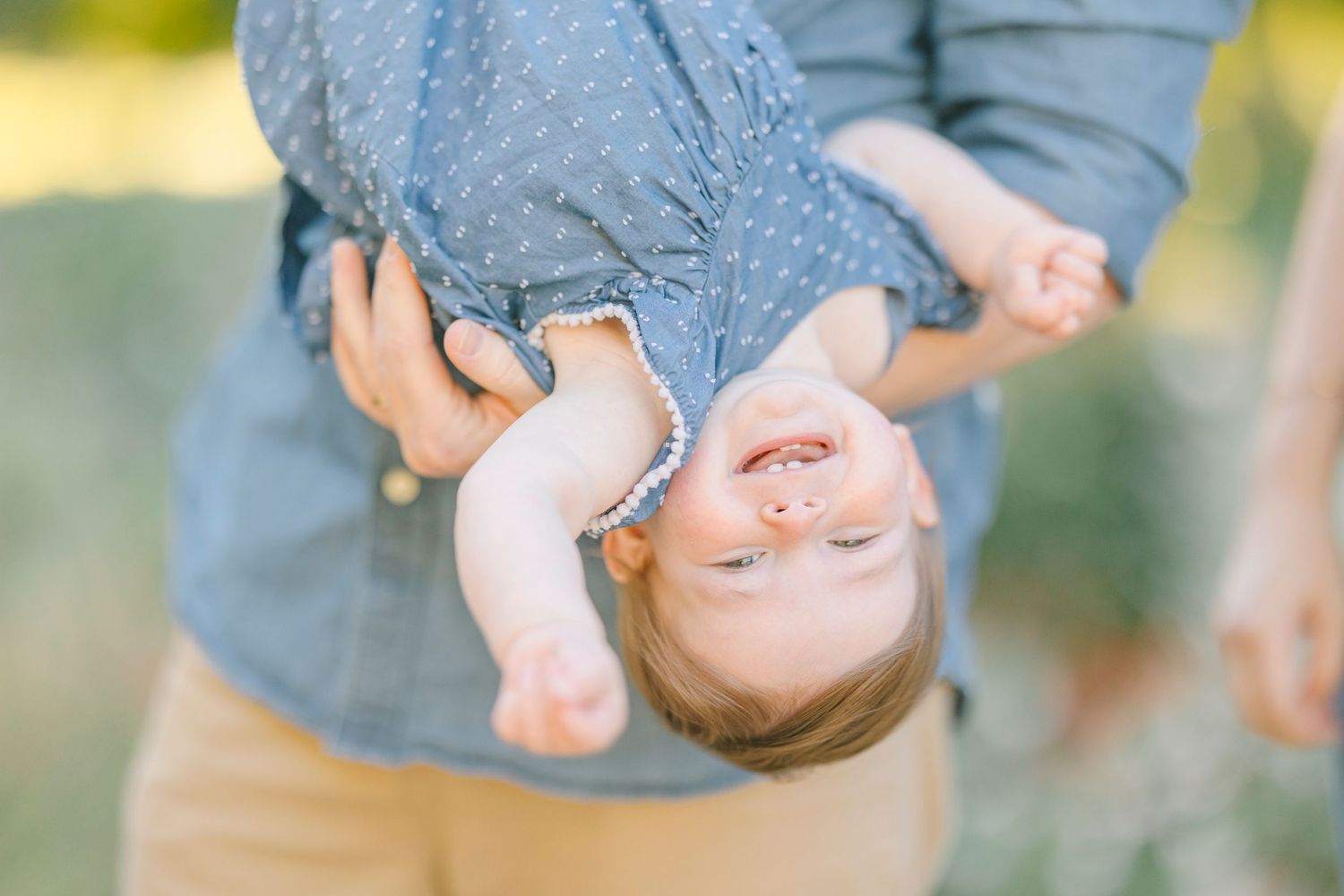 Upside down playful moment captured during a family photo session.