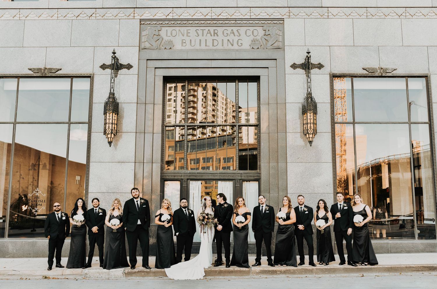 chic wedding photo of black and white wedding party in front of the carlisle wedding venue in dallas