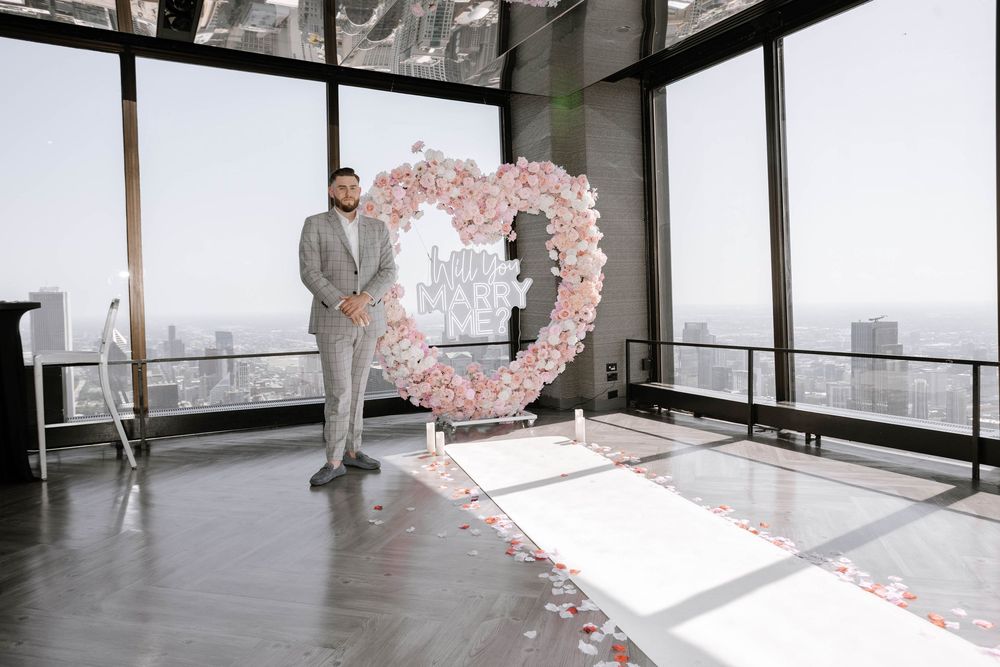 Series of photos showing people dancing and celebrating with rose petals in a modern room with large windows.