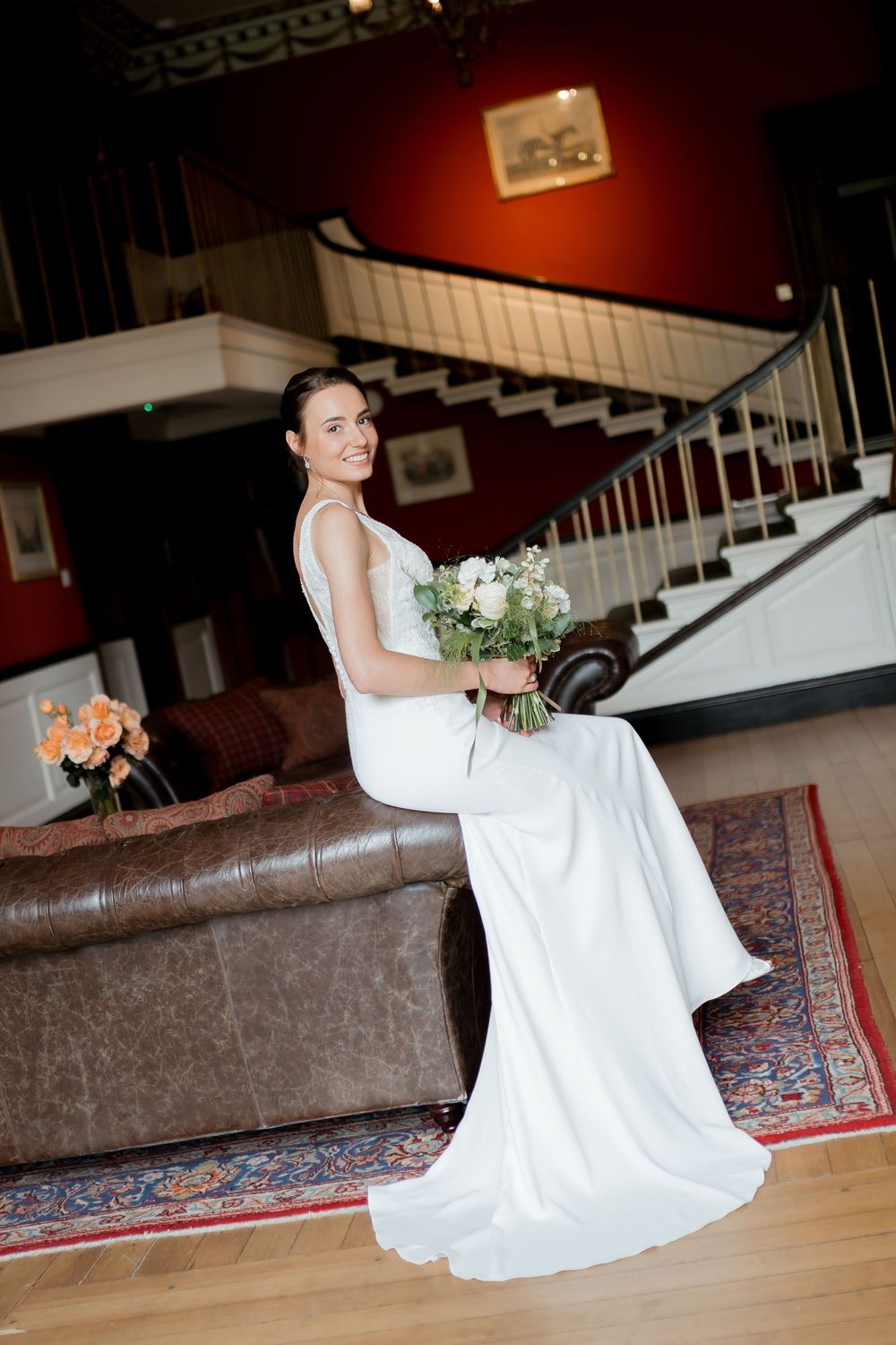 A sequence of photos showing someone in a white wedding dress sitting gracefully on hardwood floors near a staircase.