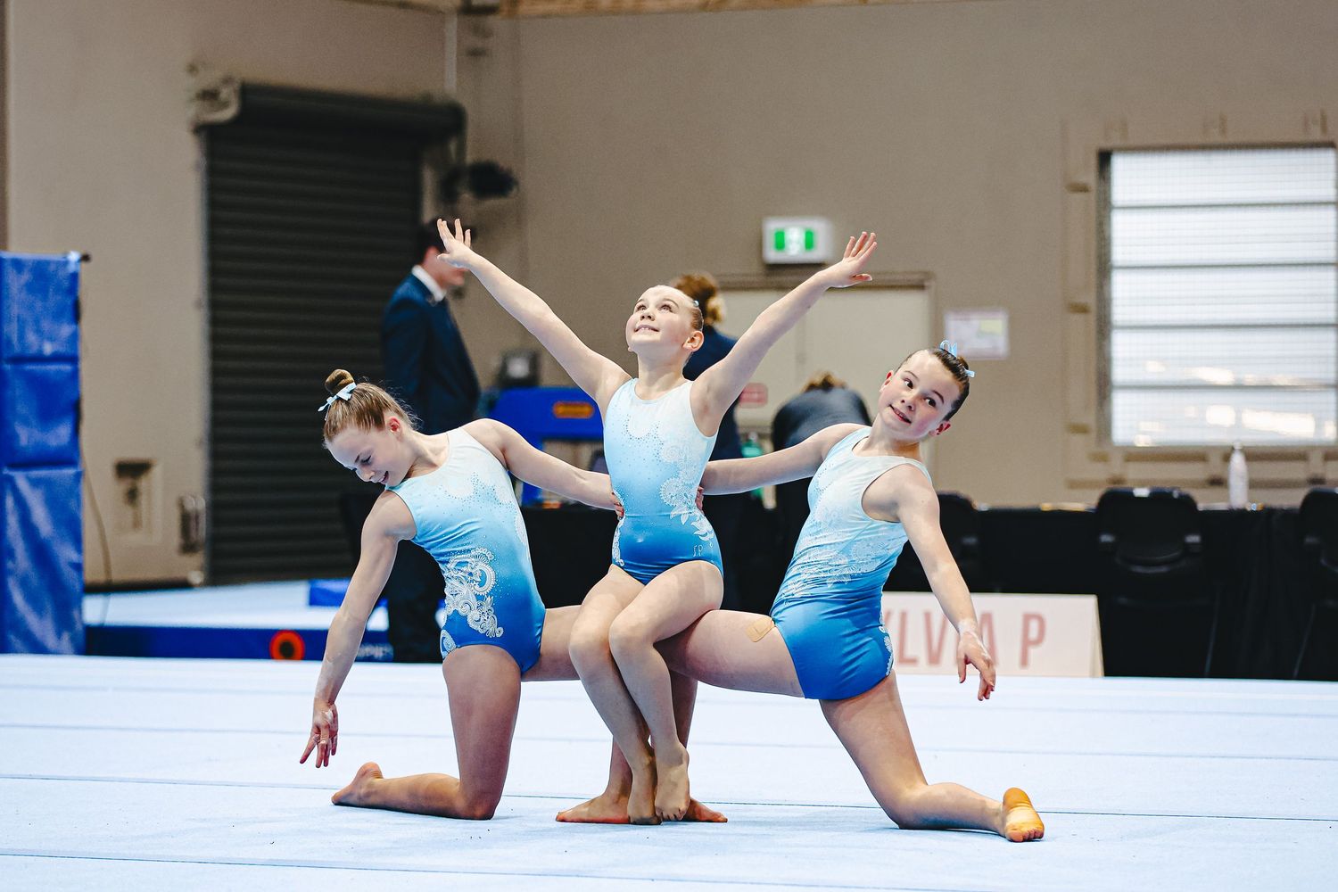 Four gymnastics photos show a person performing advanced handstands and poses against a studio wall background.
