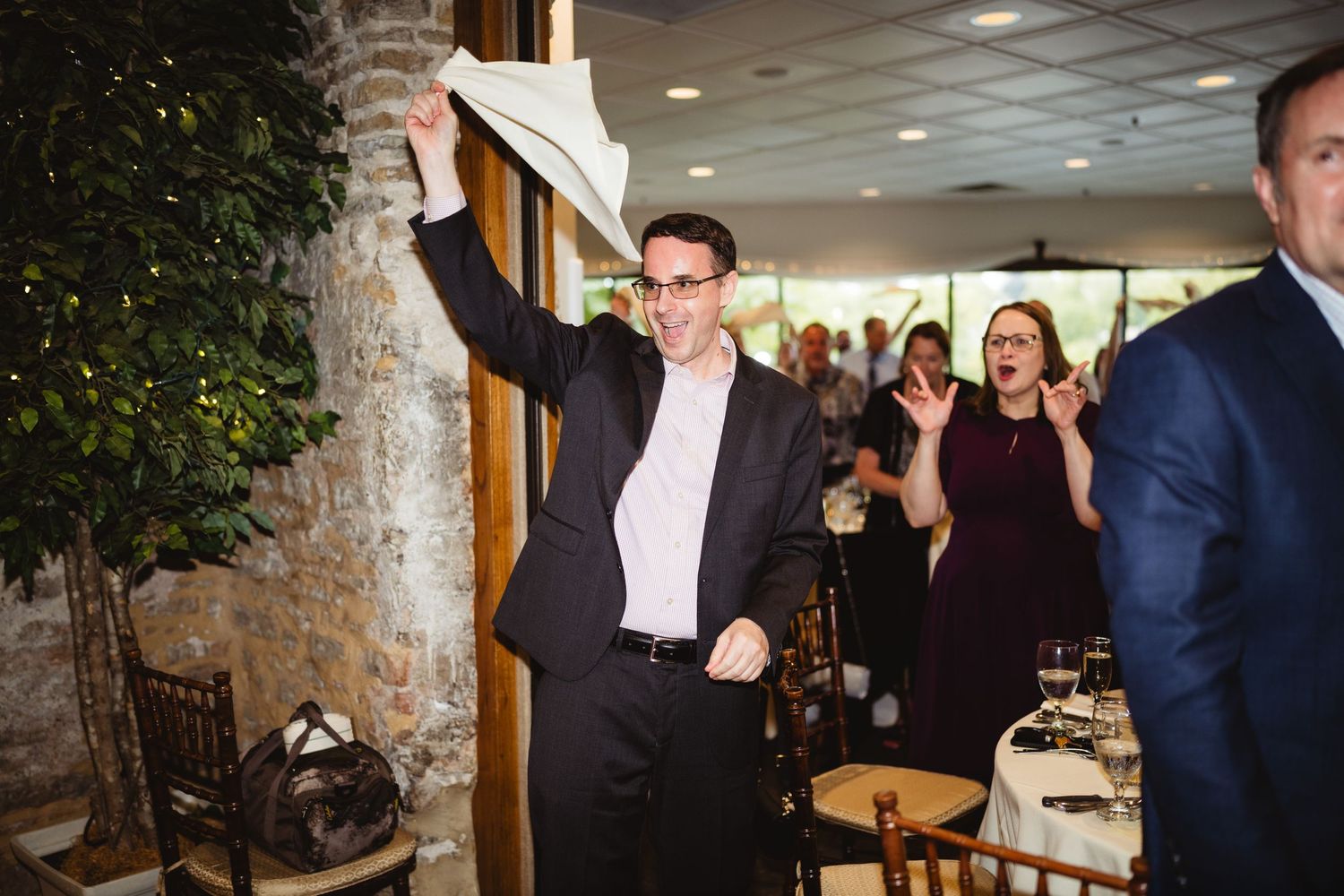 A series of candid reception photos showing guests mingling and socializing at a formal indoor event.