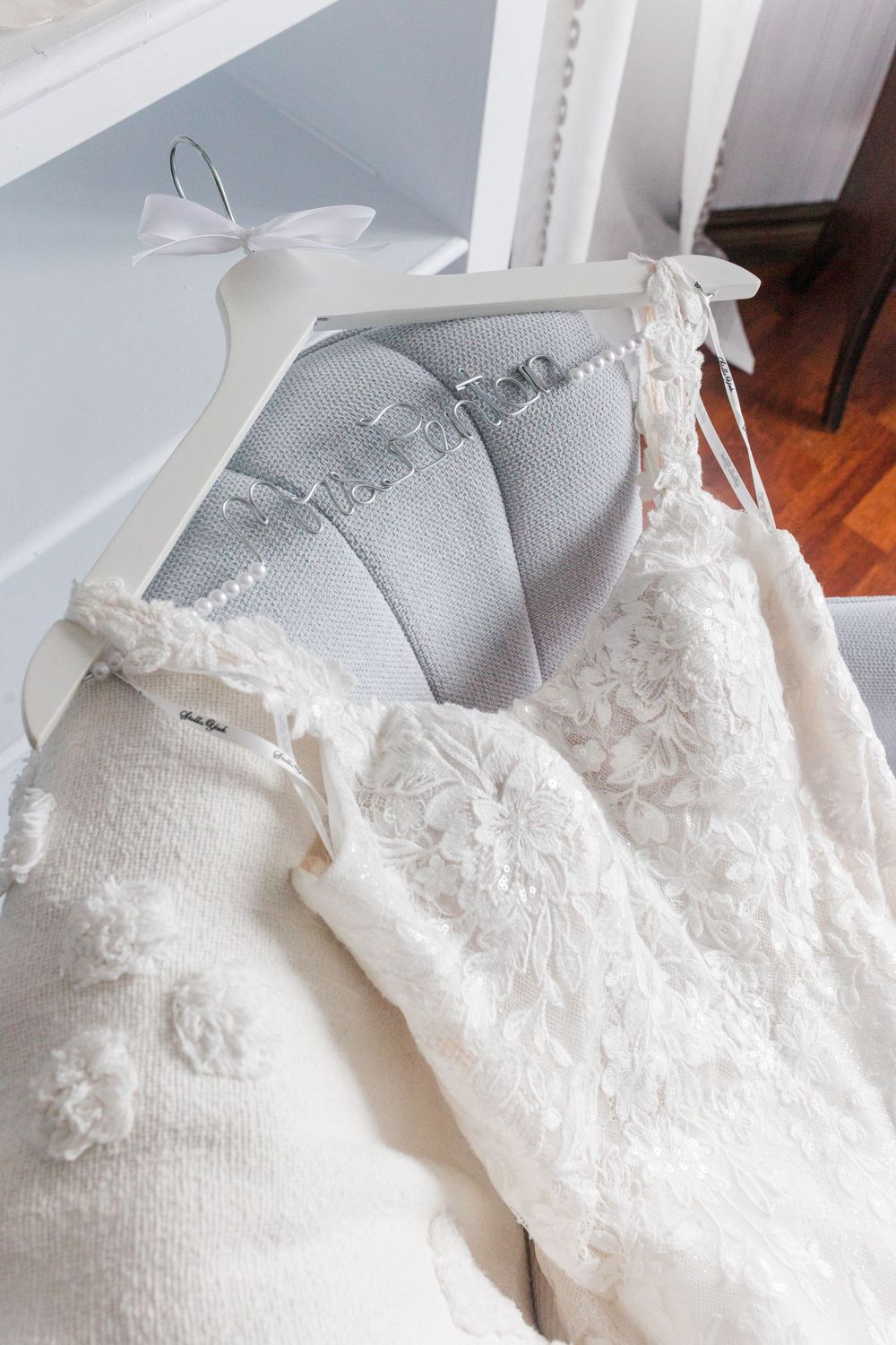 Decorative white lace and ribbons embellish a delicate fabric surface creating an elegant textural pattern.