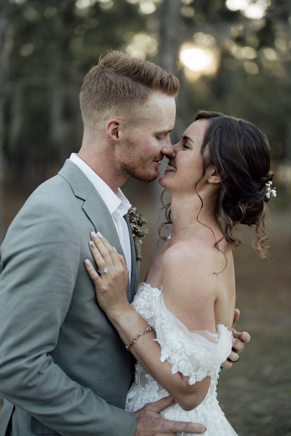 Romantic wedding photos captured in a wooded setting during golden hour.