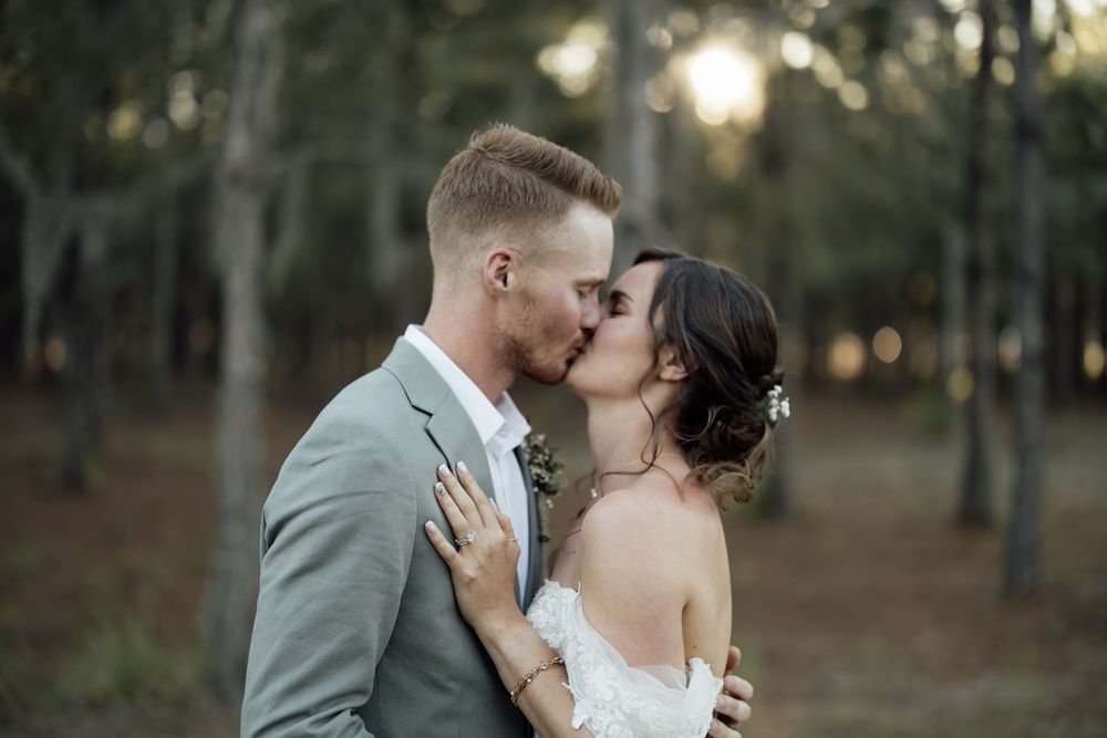 Wedding portraits taken in a scenic forest setting with natural golden light.